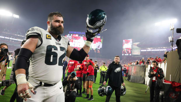 Jason Kelce raises his helmet as he walks off the field